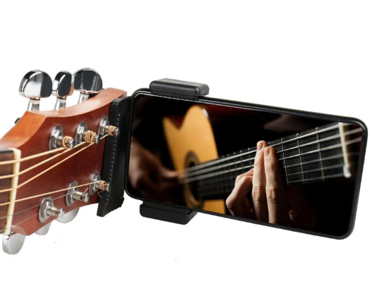 Guitar Phone Holder clipped to a guitar headstock
